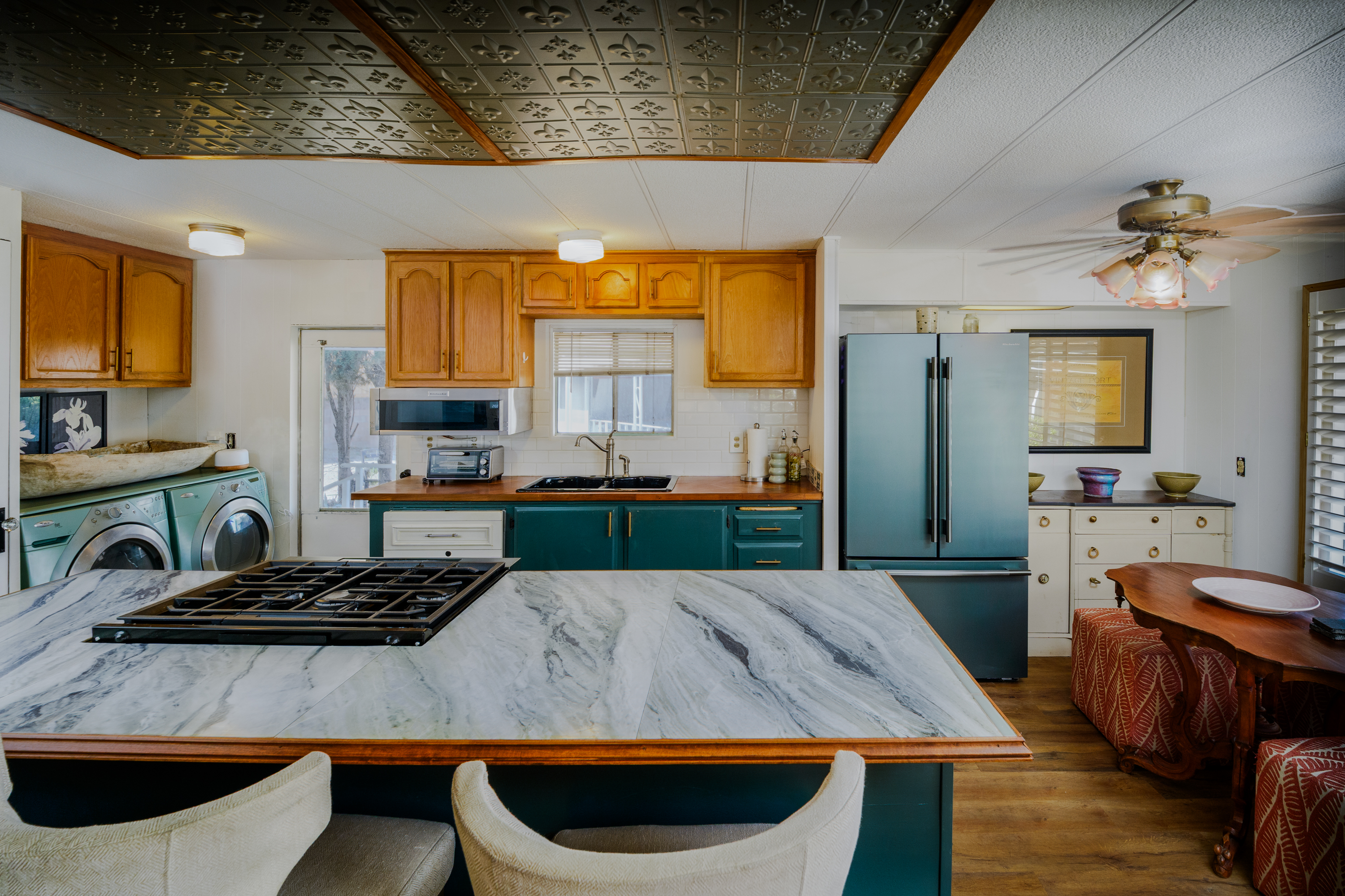 Colorful residential kitchen with a large stone island